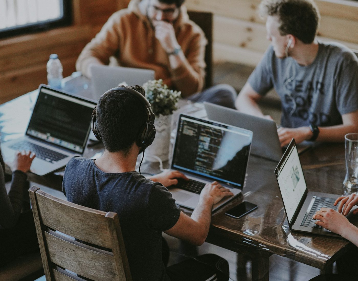 Team working together around a table with laptops